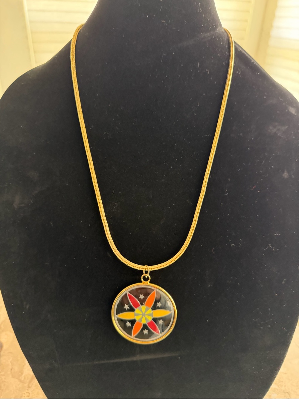 Gold-Tone Compass Star Pendant Necklace with Yellow and Red Accents